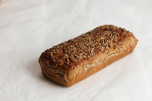 Healthy vegan oat and coconut loaf bread, cake on a cooling rack Grey stone background