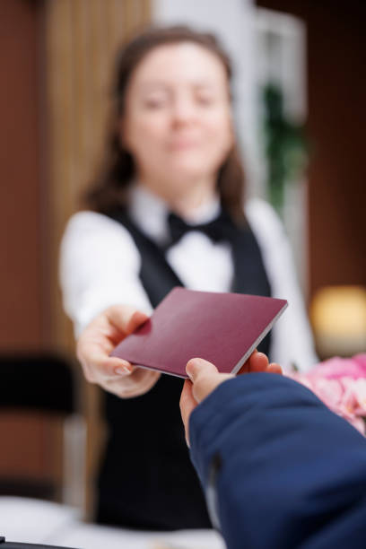 istock Concierge returns passport to traveler 1633460724