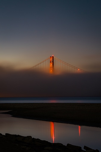 An aerial view of the iconic Golden Gate Bridge in San Francisco, USA, shrouded in fog