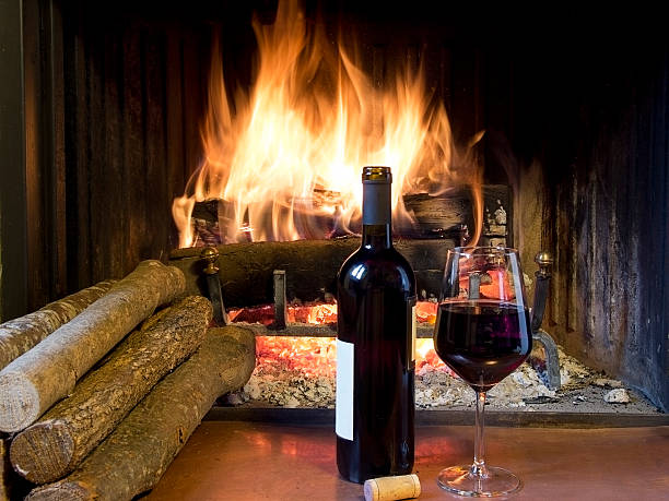 istock Glass of wine next to a fireplace 163349083