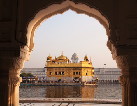 Amritsar Golden Temple - India. Framed with windows from west side. focus on temple