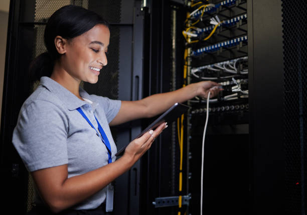 istock Server room, tablet and engineer woman with connection cable for maintenance or software update at night. Cybersecurity, it programmer or female with technology for database networking in data center 1633491570