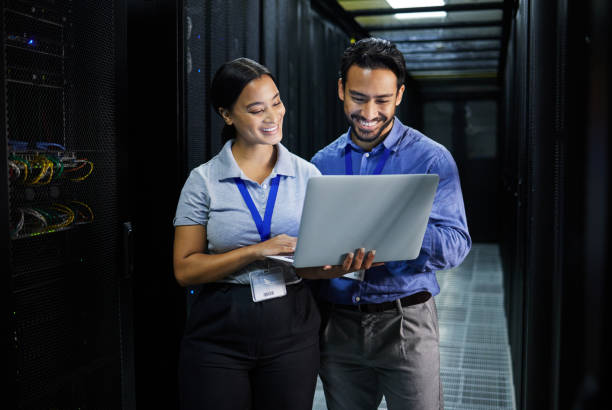 istock Server room, laptop and people team for software management, system upgrade and cyber security. Teamwork technician, engineering or programmer staff on computer, information technology or programming 1633491909