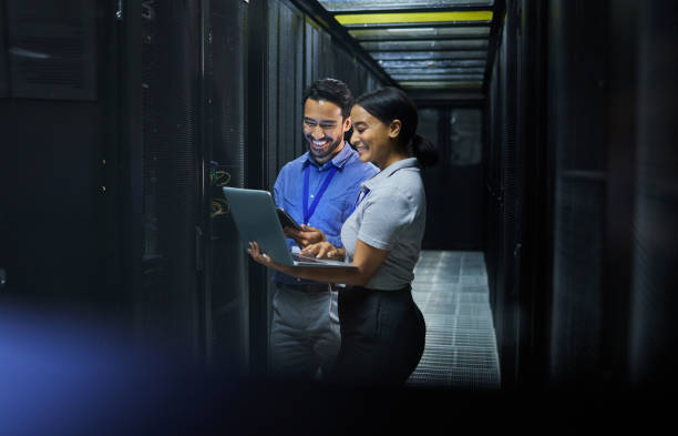 istock Server room, laptop and technician people for software management, system upgrade or cyber security. Teamwork, data center and engineer or programmer employees, information technology and programming 1633491911
