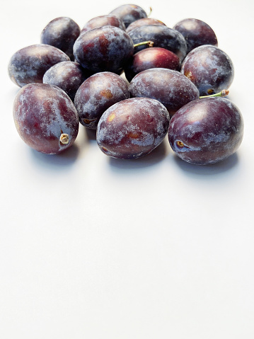 Plums fruit on white background with copy space
