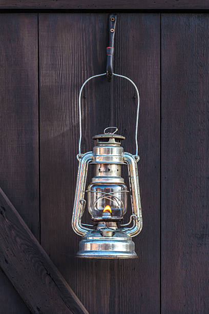 istock Old fashioned lantern on a brown wooden wall 163349410