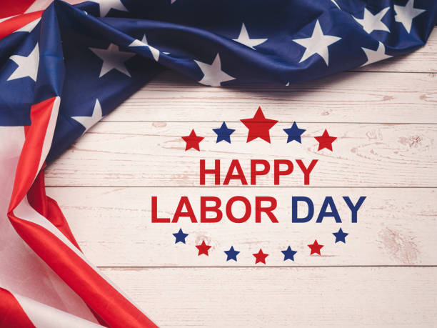 Happy labor day text over a wooden table and American Flag Happy labor day text over a wooden table and American Flag. Top view. labor day stock pictures, royalty-free photos & images