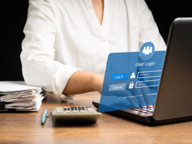 istock Businesswoman using a laptop login to the network system on a virtual screen 1633505732