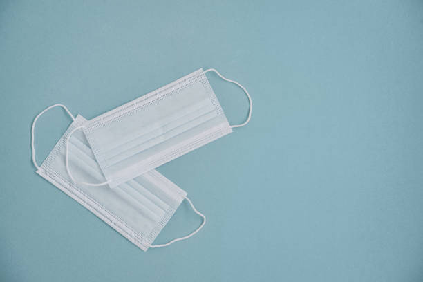 istock Tipical surgical masks with rubber ear straps 1633511663