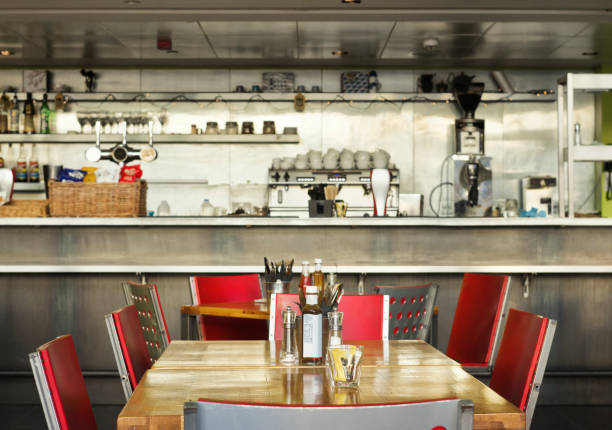 Table, English diner with bar, indoor Photographed from outside. Shallow focus (on the bottle on the table) diner stock pictures, royalty-free photos & images