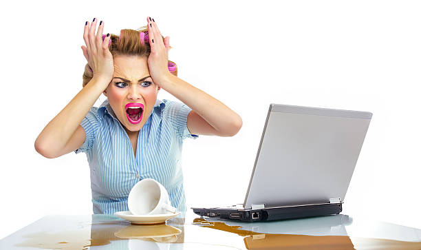 Angry business woman with chaos on workspace. Dirty desktop stock photo