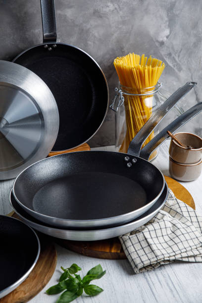 istock pots and pans in the kitchen, on a gray background 1633518028