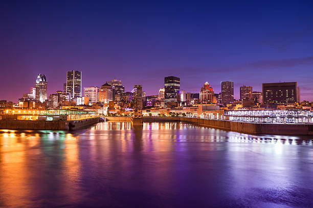 Downtown city skyline at night, showing St. Lawrence River, Montreal, Quebec, Canada