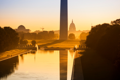 Washington DC Monument and the US Capitol Building and grounds viewed across the reflecting pool from the Lincoln Memorial on The National Mall USA