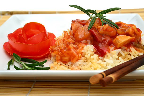 Sweet and sour chicken meal with vegetables and herbs