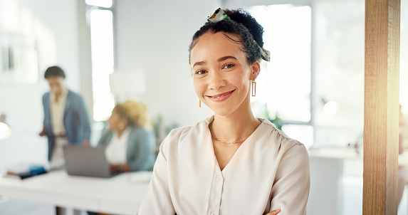 Arms crossed, pride and portrait of a business woman with confidence, happiness and smile in office. Expert, success and employee with trust, smiling and happy about job at a corporate company