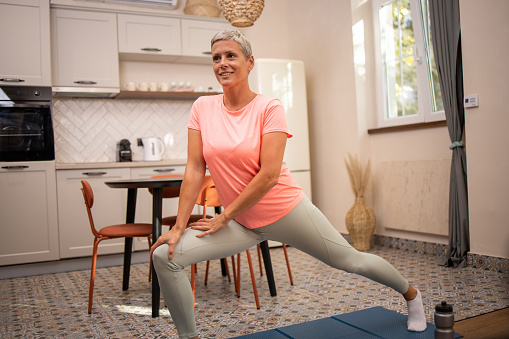 Healthy woman exercising at home