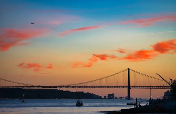 Photo of Beautiful summer sunset over The Tagus river in Lisbon, Portugal.