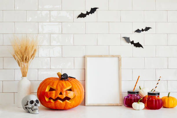 istock Picture frame template, Halloween decorations, Jack o lantern, pumpkins, skull, drinks, bats on tile wall in Scandinavian style home interior 1633560456