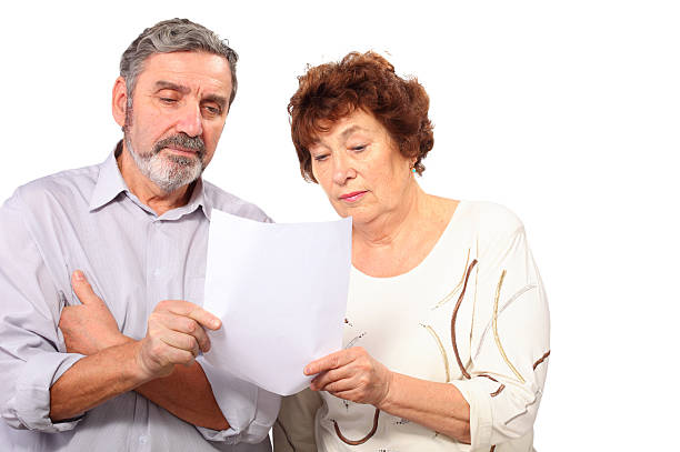 istock Serious senior couple hold paper list in hands 163356071