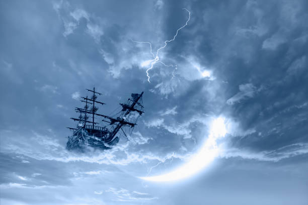 istock Fantasy old ship flying over stormy clouds with lightning crescent moon in the background 1633577335