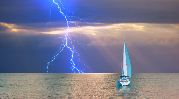 istock Sailing yacht in a stormy weather with lightning 1633579516