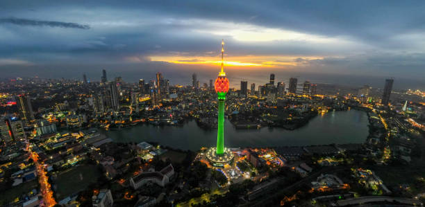 Lotus Tower aerial view , Colombo , Sri Lanka The Lotus Tower is an iconic telecommunications and observation tower in Colombo, Sri Lanka. Standing at approximately 356 meters (1,168 feet), it is one of the tallest towers in South Asia. Its design is inspired by the lotus flower, symbolizing purity and unity. The tower serves as a hub for broadcasting and telecommunication services and offers a panoramic view of Colombo from its circular observation deck. It represents a symbol of modernity and progress for Sri Lanka and is a popular tourist attraction. sri lanka business stock pictures, royalty-free photos & images