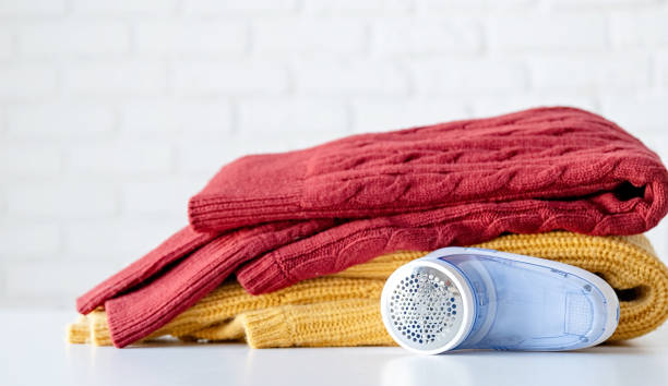 istock anti-pilling razor machine lying next to pile of sweaters 1633601179