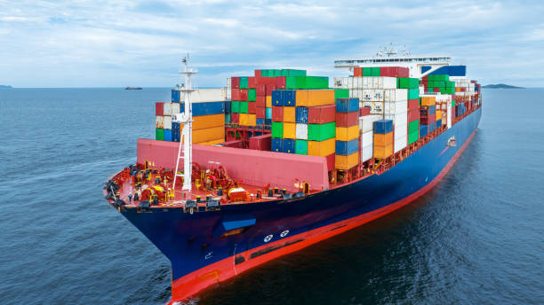 istock Aerial side view of  cargo container ship carrying container from custom container depot go to ocean concept freight shipping by ship service on blue sky .Freight Forwarding 1633601929