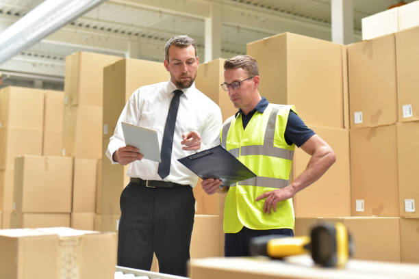 istock Worker and Manager in a warehouse in the logistics sector - transport and processing of orders in trade 1633616781