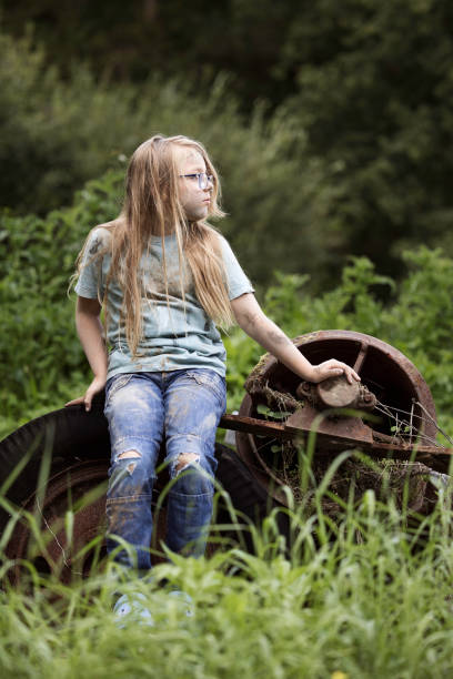 Dirty 'trailer trash' 8-year-old with brown eyes and a miserable face. Posed by model.