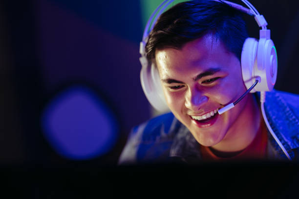 istock Player smiling at his computer screen during an online video gaming session 1633623840