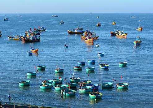 Many boats docking in fishing pier in Mui Ne town, Phan Thiet, Vietnam. Mui Ne is a coastal fishing town in the Southern Vietnam.