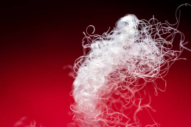 istock Extreme macro of polyester stable fiber on red background 1633628386