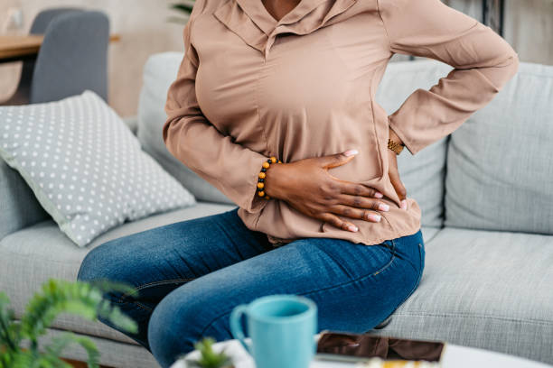 istock Young Woman Having Back Pain While Sitting On The Sofa At Home 1633633196