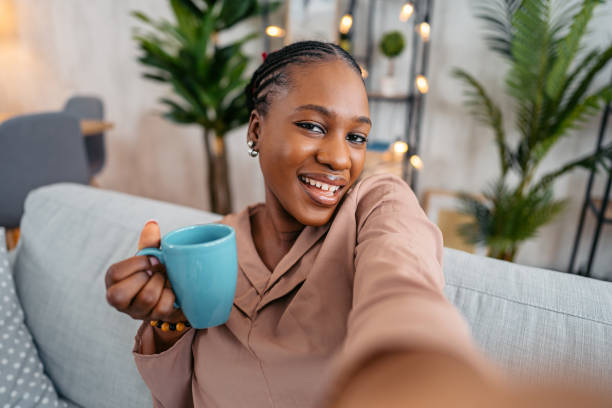 istock Young Woman Taking Selfies On The Sofa At Home 1633636714
