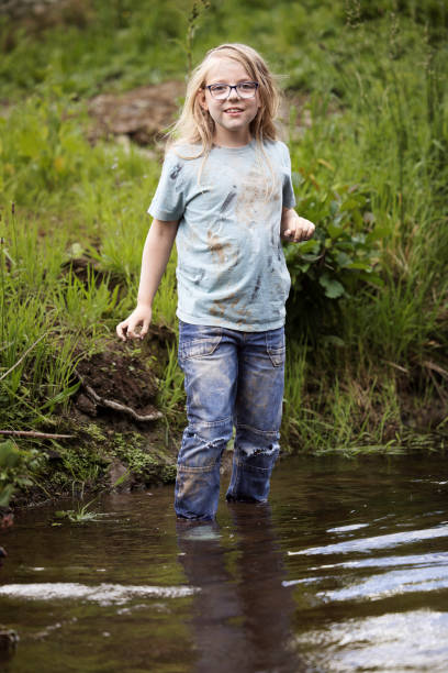 istock Eight-year-old girl paddling in a stream 1633657026