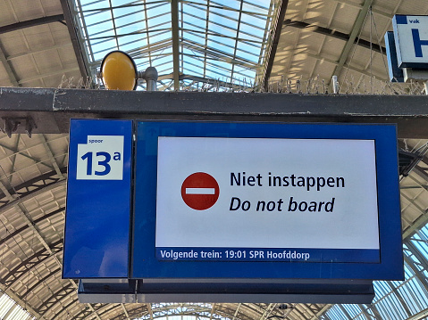 A sign Niet instappen or do not board at a train station in the netherlands shown on platform