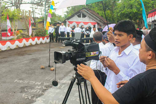 Banjar, West Java - August 17 2023: Journalists covering the morning ceremony in Jelat village, Banjar on Indonesia's independence day.