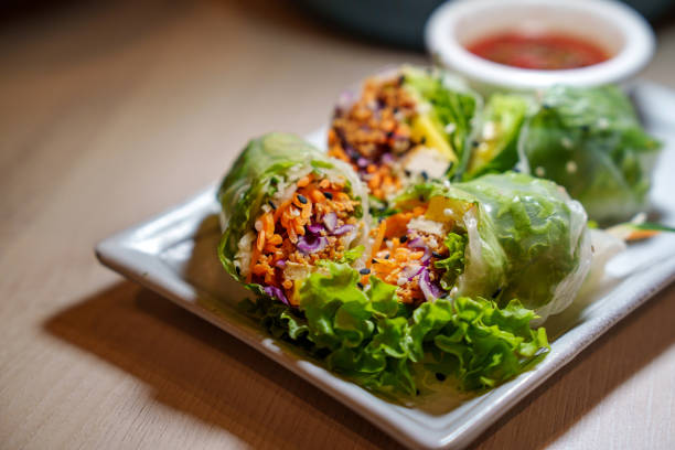 Spring roll made of rice paper filled with fresh vegetables, representing a delicious vegetarian food option.