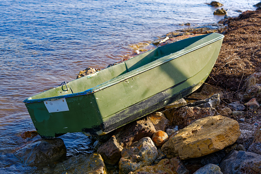 Green boat at seashore of Giens Peninsula on a sunny late spring day. Photo taken June 8th, 2023, Giens, Hyères, France.
