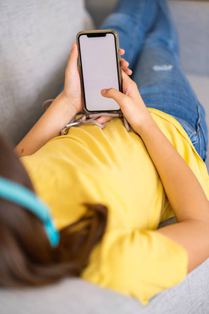 istock Mobile phone in girl hands 1633725255