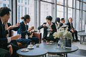 Group of multiracial Asian business participants casual chat coffee break conference event