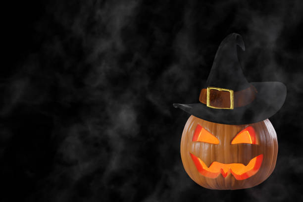 istock Halloween pumpkin jack o lantern in a witch hat on a black background in fog. 3D rendering 1633779470