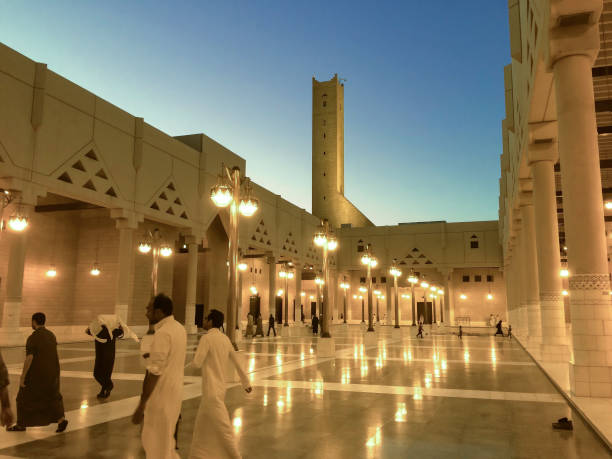 Riyadh, Saudi Arabia - February 27, 2015: Children and adults walking by Riyadh's Grand Mosque, at sunset, before pray time.