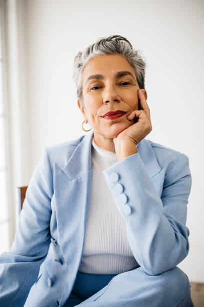 istock Success and style: Senior business woman dressed in a suit at work 1633789249