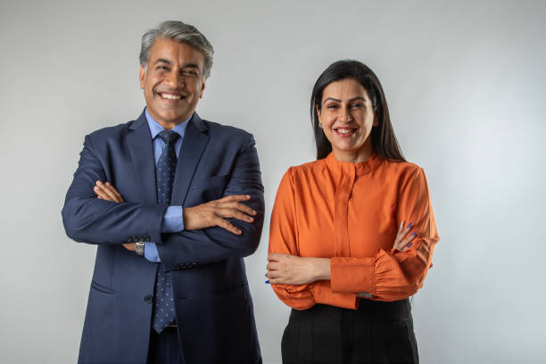 istock Smiling business partners standing against white background 1633797713