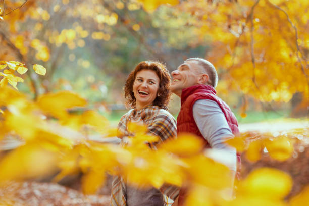 istock smiling modern couple in park walking 1633797986