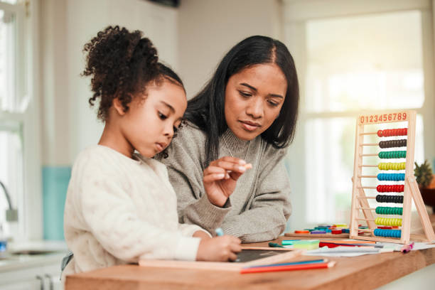 istock Learning, math and mother help kid with homework for homeschool lesson, project or academic assignment. Smile, happy and parent or mom support child with education, development and studying together 1633810400