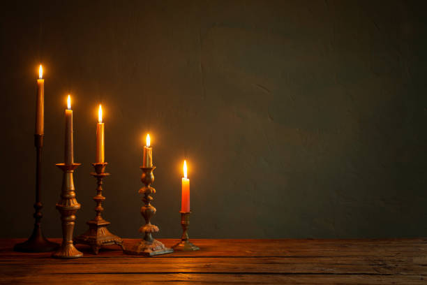 istock burning candles in vintage candlesticks on dark background 1633816981